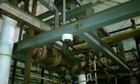 Dome camera mounted among industrial building services