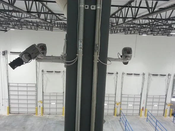 Network cameras mounted beside warehouse structural steelwork